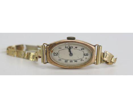 A 9ct Gold Ladies Wristwatch with Buren 15 jewel manual wind movement and on a gold plated bracelet. Running 