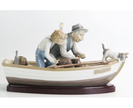 A Lladro figure group No 5152 'Fishing with Gramps/Paloma', 38cm long. Boy missing fingers and fishing rod missing