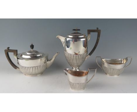 A matched four-piece tea and coffee service, various makers and dates, of oval form with half reeded decoration, includes cof