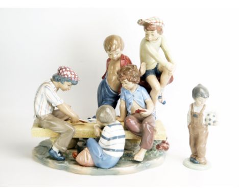 A large Nao porcelain figure group of street urchins playing cards on a bench, 32cm wide, 33cm high. together with a Nao figu