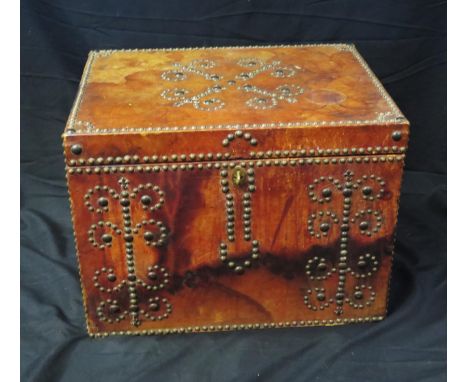 A red leather bound trunk, with metal stud decoration, having a hinged rectangular top, 51cm wide. 