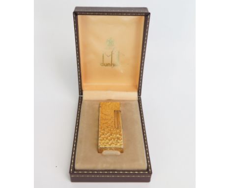 A gold plated Dunhill 70 lighter, with bark design, cased. 
