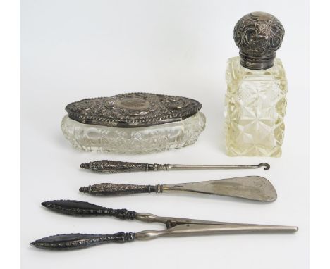 Two clear glass and silver mounted dressing table jars, steel glove stretchers, shoe horn and button hook. 