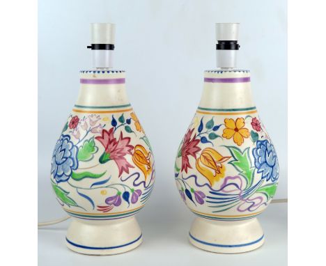 A pair of Poole pottery table lamps of ovoid form with painted floral decoration, overall height including fittings 31cm 