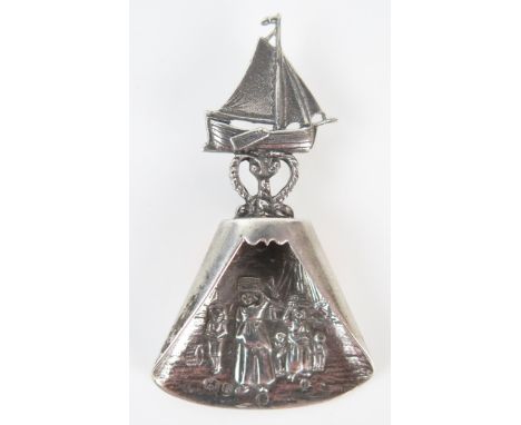 A continental silver caddy spoon the bowl decorated with fisher women landing the catch, the handle in the form of a fishing 