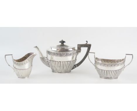 A Victorian silver bachelors three-piece tea service, maker Martin, Hal, &amp; Co, London, 1889/90, of oval form with half re