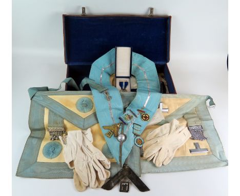 Two Masonic aprons, sash and assorted jewels contained in a leather case. 