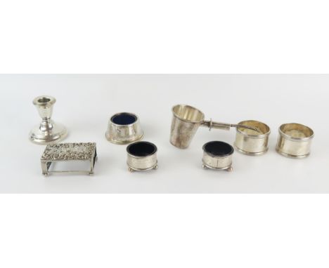 A mixed collection of silverwares, various makers and dates, includes a pair of salts, a pair of napkin rings, desk candlesti