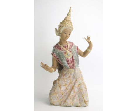 A Lladro figure of a kneeling Siamese dancer, in traditional headdress, 46cm high 