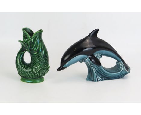 A Poole pottery model of a leaping dolphin, and a Dartmouth Pottery glug glug jug, 18cm high. 