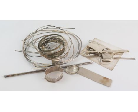 A collection of scrap silver wire, mounts, spoon, napkin ring and off cuts, gross weight 599gms, 19.29ozs 