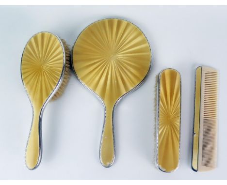 A silver an enamel dressing table set, comprising hand mirror, hair brush, clothes brush and comb. (4). 