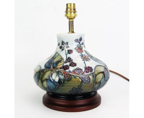 A Moorcroft pottery table lamp, in the Bramble pattern, of squat globular form, with tube-line decoration, mounted on a polis