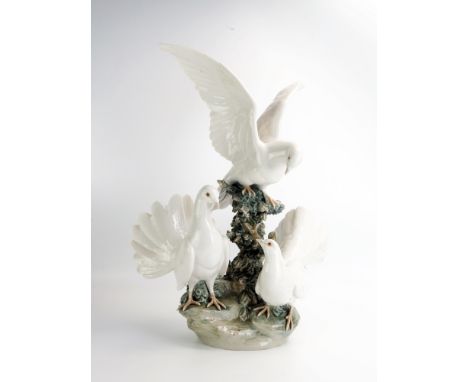 A large Lladro group of doves on a rocky outcrop, 51cm high A/F
