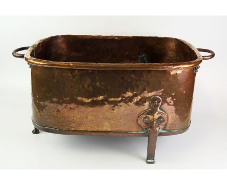 An 18th century Dutch brass  basin, of rectangular outline with loop carrying handles raised on three peg feet, 57cm wide. 