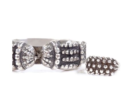 An unmarked silver hinged bangle, relief decoration, internal diameter 56mm, and a silver Keeper ring, size P, 39.4g total, (