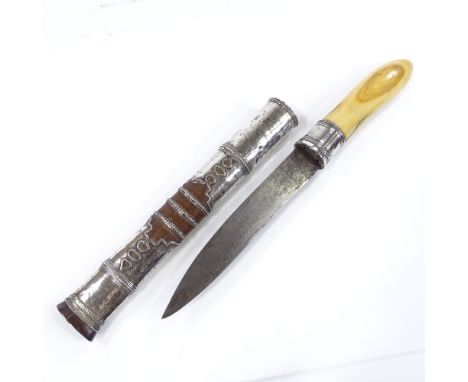 A Burmese silver-mounted dagger, circa 1900, with ivory hilt and original silver-mounted wood scabbard, length overall 35cm 