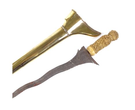 An Indonesian Kriss dagger, with ornately relief carved ivory hilt and gilt-brass scabbard, overall length 44cm 