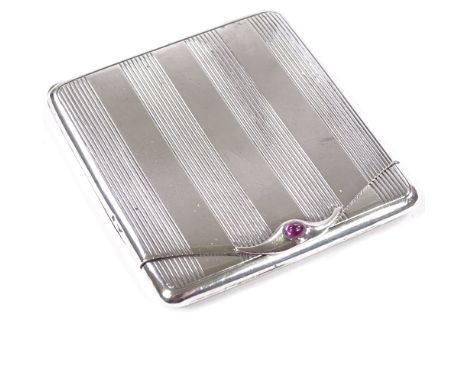 CARTIER - an Art Deco French silver matchbox case, with cabochon ruby thumbpiece, engine turned decoration and gilt interior,