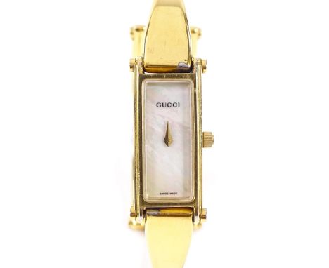 GUCCI - a lady's gold plated stainless steel 1500L quartz bangle wristwatch, rectangular mother-of-pearl dial with 5 jewel mo