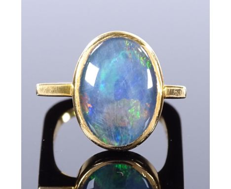 A modernist 18ct gold black opal ring, square stylised shank, maker's marks GH, hallmarks London 1970, setting height 15.2mm,