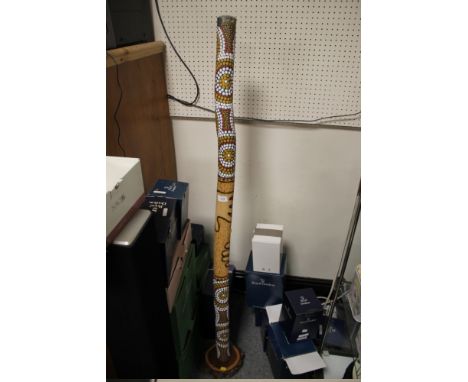 A WOODEN DIDGERIDOO??? ON STAND  