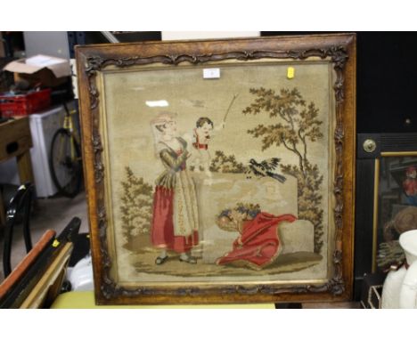 A VINTAGE NEEDLEWORK IN A CARVED WOODEN FRAME 