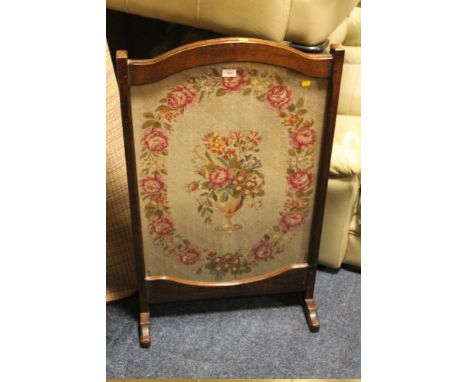 AN OAK EARLY 20TH CENTURY GLAZED NEEDLEPOINT FIRESCREEN