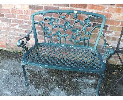 A PAINTED GREEN CAST GARDEN BENCH