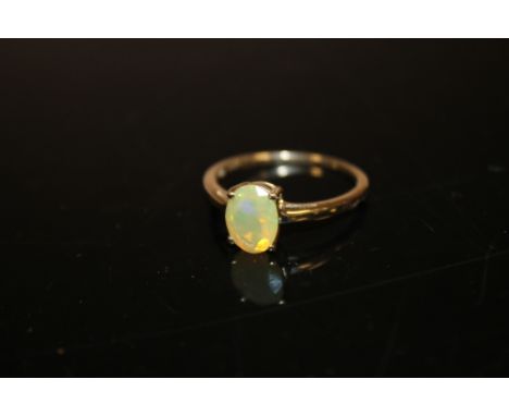 A 10K GOLD DRESS RING SET WITH A FIRE OPAL STYLE STONE