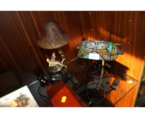 A BUTTERFLY SHAPED BANKERS LAMP TOGETHER WITH A FAIRY AND TOADSTOOL SHAPED LAMP (2)