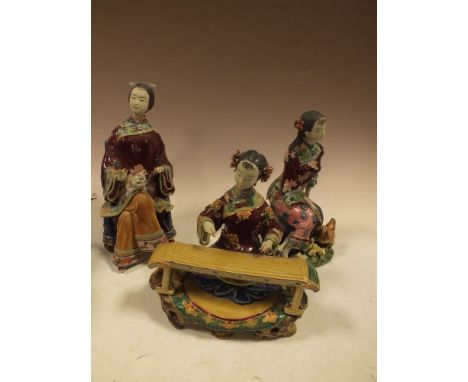 THREE ORIENTAL CERAMIC SEATED LADY FIGURES 