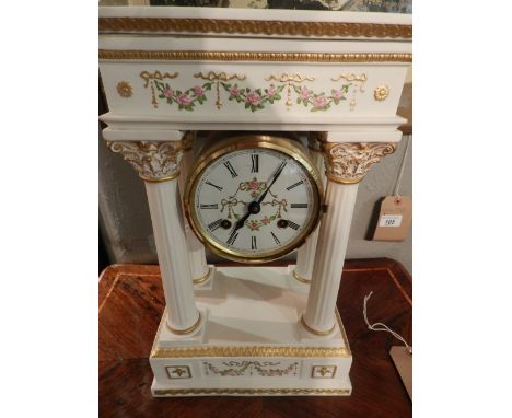 A Franklin mint bisque porcelain portico clock, in the Louis XVI style, parcel gilded and painted with roses, set eight-day c