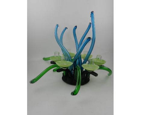 A six branch glass table light, having green and blue tentacle shaped arms.