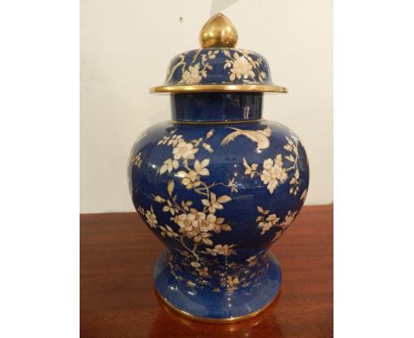 A Spode porcelain baluster shaped urn, decorated with cranes and foliage, bears factory mark to base. H: 30cm