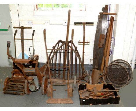 VARIOUS IRON BYGONES, INCLUDING TWO PUSH LAWNMOWERS, SACK TRUCK, HAY MANGERS, PIT SAWS, RIDDLES AND GARDEN HAND TOOLS, ETC
