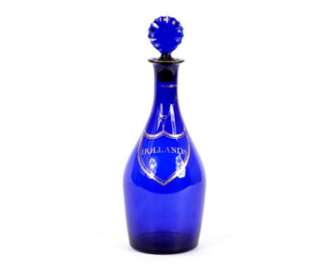 AN EARLY 19TH CENTURY ENGLISH BLUE GLASS DECANTER AND MATCHED STOPPER, GILT WITH LABEL HOLLANDS, THE STOPPER INSCRIBED B, 25C