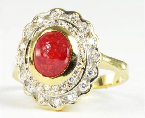 A RUBY CABOCHON AND DIAMOND CLUSTER RING IN GOLD, MARKED 750, 6.4G GROSS 