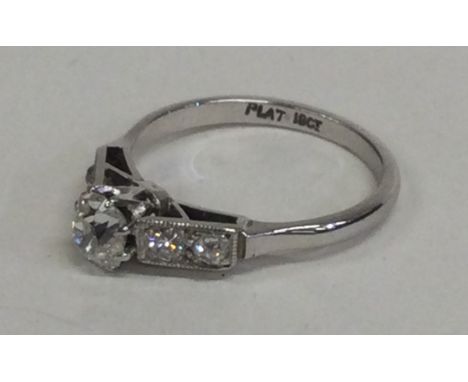 An attractive diamond single stone ring in claw mount to diamond shoulders. Approx. 4 grams. Est. £400 - £600.