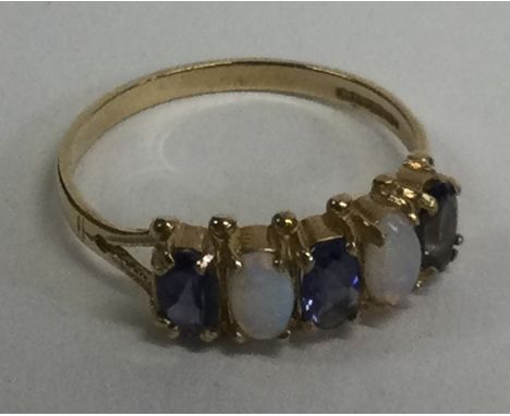 An opal and amethyst half hoop ring in 9 carat setting. Approx. 1 gram. Est. £20 - £30.