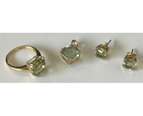 A good asscher cut single stone ring in 9 carat claw mount together with matching pendant earrings. Approx. 7 grams. Est. £10
