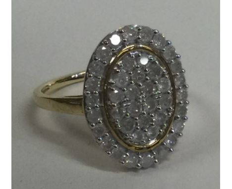 A large diamond oval cluster ring in 9 carat setting. Approx. 4 grams. Est. £60 - £80.