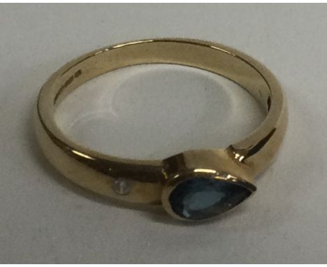 A 9 carat blue stone ring. Approx. 1 grams. Est. £20 - £30.