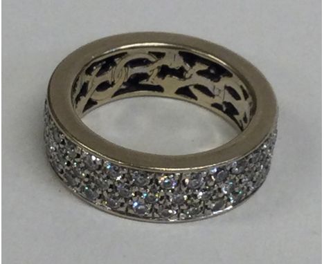 A large diamond three row full eternity ring in 14 carat gold setting. Approx. 14 grams. Est. £200 - £300.