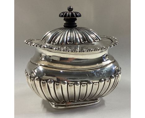 A fluted silver tea caddy with hinged cover. London 1898. By Mappin & Webb. Approx. 194 grams. Est. £150 - £200.