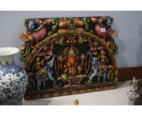 A heavily carved Indian panel
