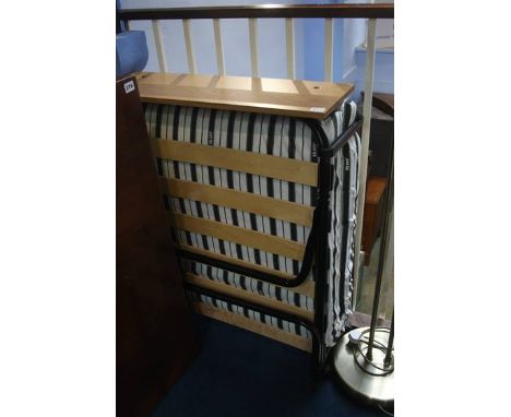 A folding bed and a lamp