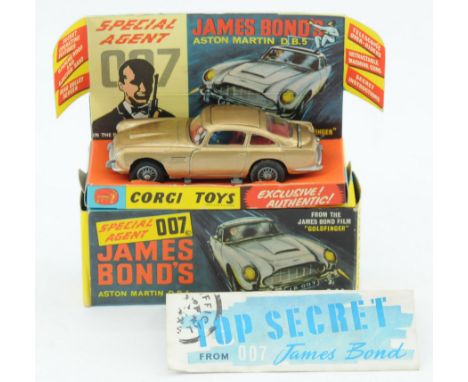 Corgi Toys 261 "James Bond" Aston Martin DB5 Taken from "Goldfinger" - Gold body, red interior with "James Bond & Bandit" fig