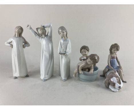 A Lladro porcelain figure group of two children in a barrel shaped bathtub, a Lladro porcelain model of a girl seated on a St