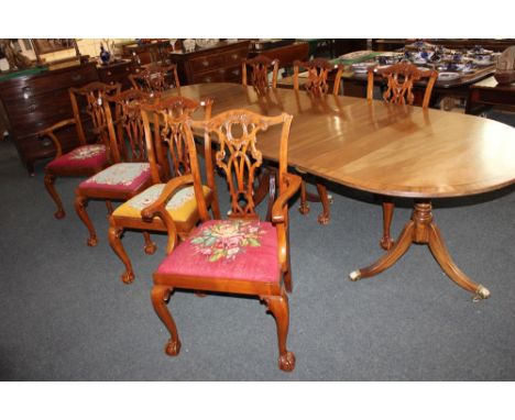 A set of eight mahogany Chippendale style dining chairs with carved and pierced backs, with tapestry drop-in seats, on cabrio